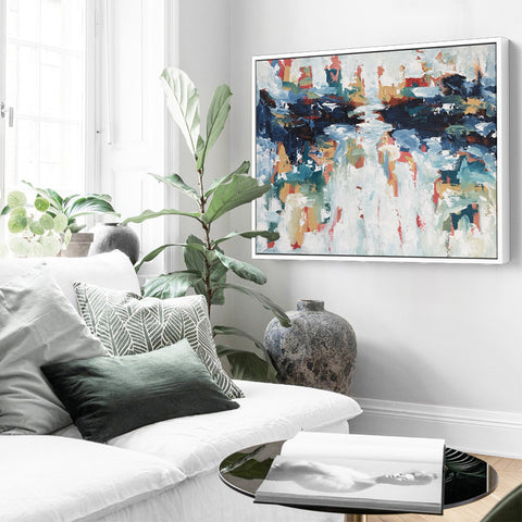 Abstract painting on a wall next to a sofa living room
