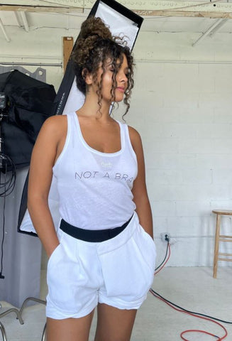woman wearing a tank top that says "not a bra" 